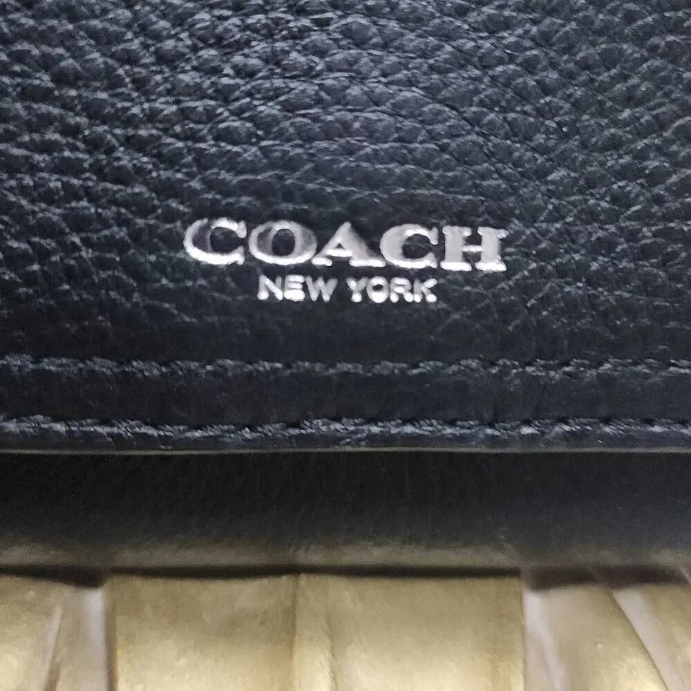Coach Avery leather phone crossbody w/ a flap closure.
